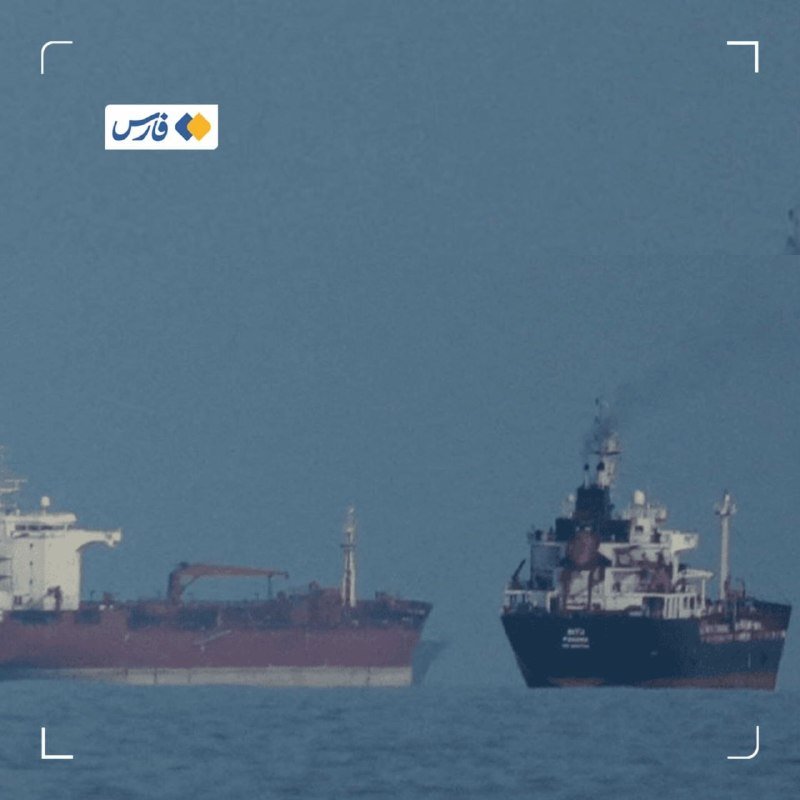 Two large cargo ships float on calm blue water, framed by a camera viewfinder overlay with a logo in the upper left.