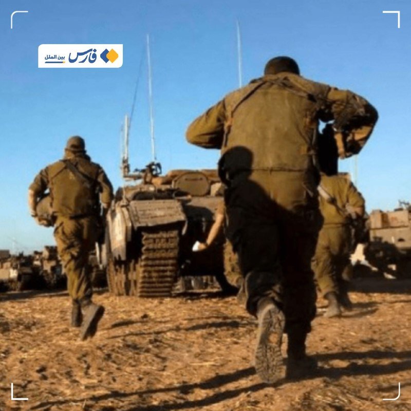 Soldiers in olive uniforms run across a dirt field toward an armored tank under a clear blue sky.