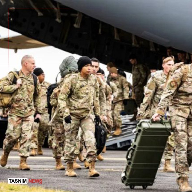 Soldiers in camouflage uniforms carrying backpacks and gear walk away from a large military aircraft on a tarmac.