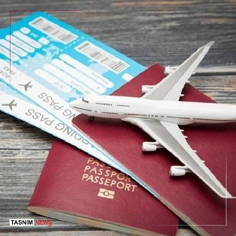 A white model airplane rests atop a burgundy passport and two blue boarding passes on a wooden surface, with a "TASNIM NEWS" watermark visible.