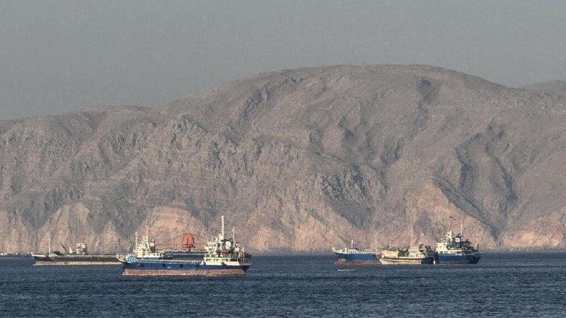 A US-brokered shipping coordination plan for the Strait of Hormuz has exposed a fundamental disagreement over what the Iran ceasefire actually means — and whether any agreement can hold without resolving the underlying economic warfare.