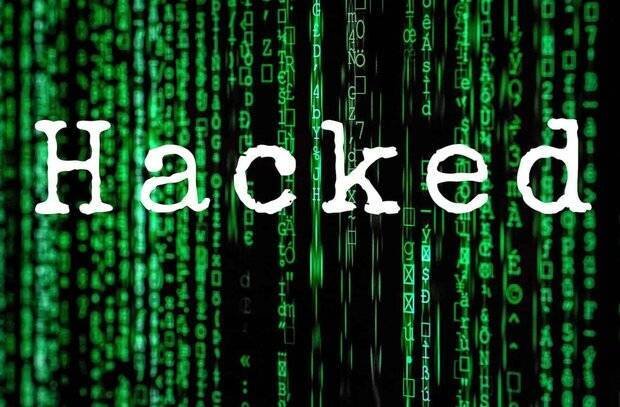 Graphic illustration showing the white word "Hacked" centered against a background of cascading green digital code characters on black.