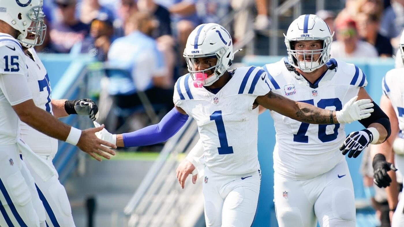 Indianapolis Colts football players in white uniforms with numbers 15, 1, and 78 celebrate on the field, with player #1 extending his hand toward #15.