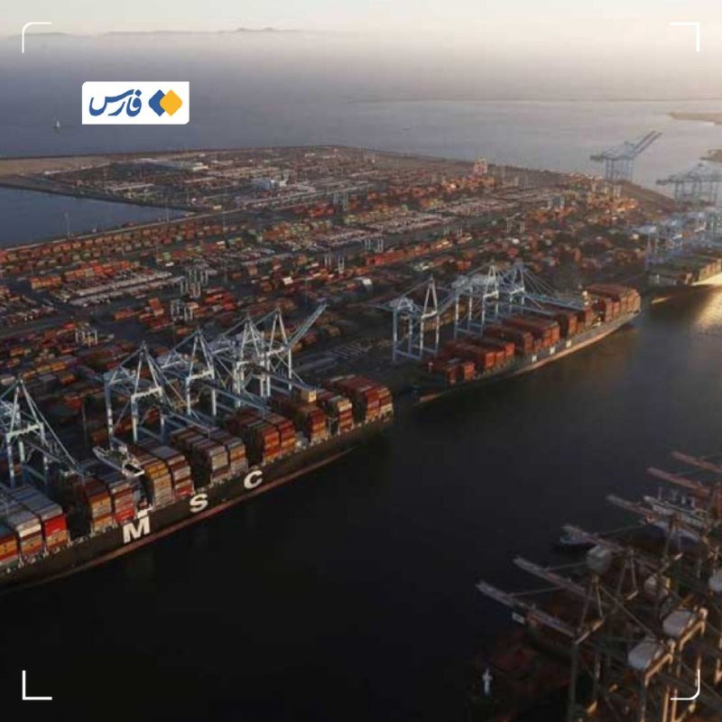 Aerial view of a large shipping port with containers, cranes, and docked cargo ships at dusk.