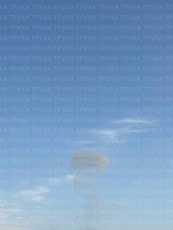 A bright blue sky with wispy white clouds fills the frame, overlaid with repeating "ТРУХА" watermark text across the image.