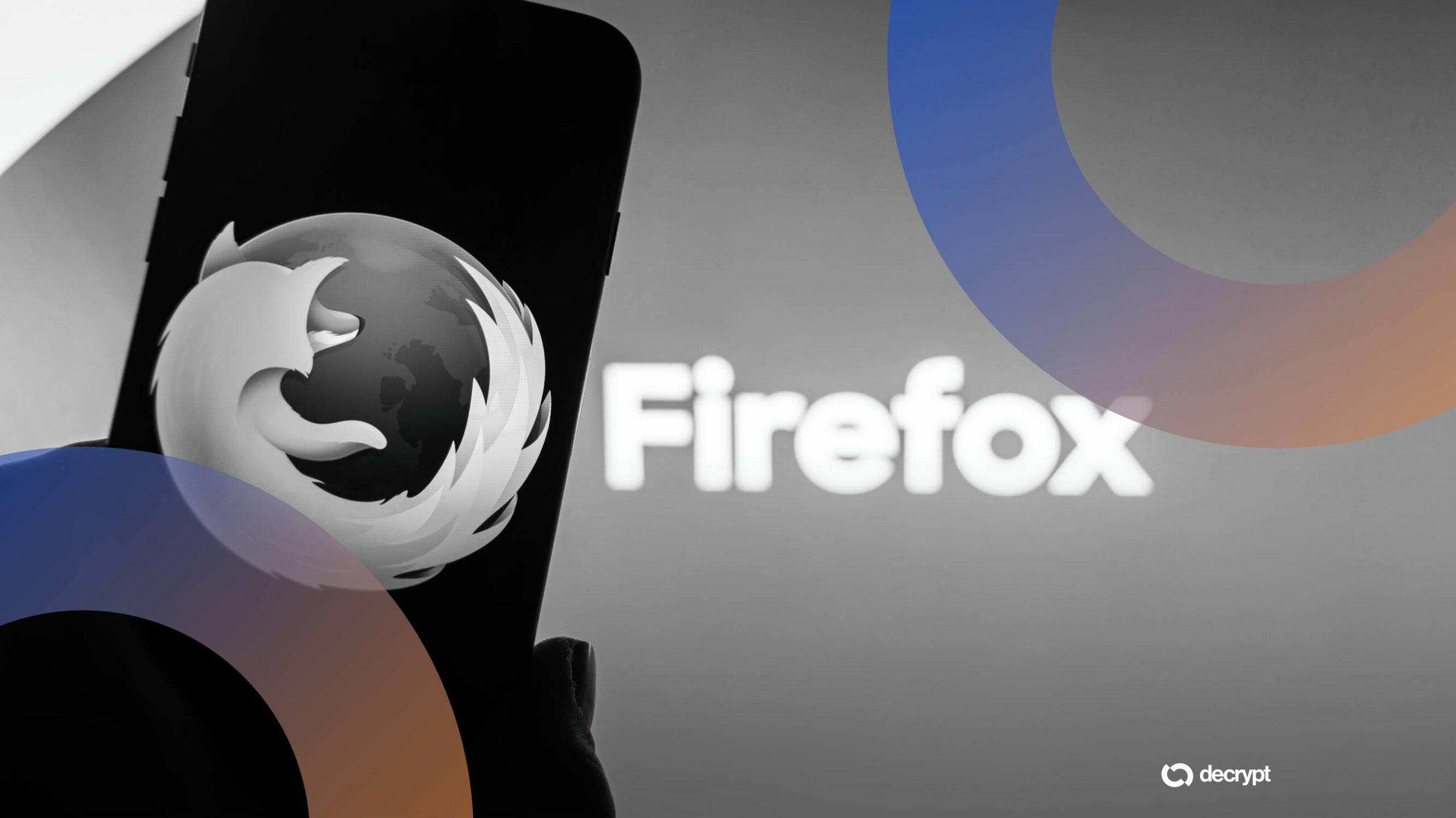 A gloved hand holds a smartphone displaying the Firefox logo, with the "Firefox" wordmark beside it against a gray background with blue and orange curved graphics.