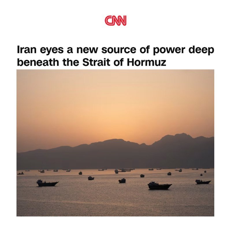 A CNN news graphic displays the headline "Iran eyes a new source of power deep beneath the Strait of Hormuz" above a sunset photograph of numerous ships anchored in a bay backed by silhouetted mountains.