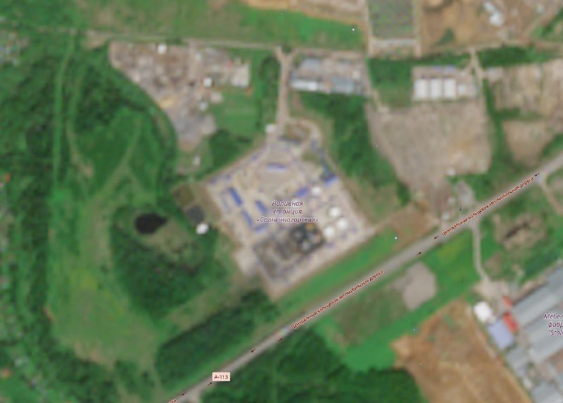 Satellite image shows an industrial facility with storage tanks, labeled in Cyrillic as a compressor station, situated near a highway marked "Д-113."