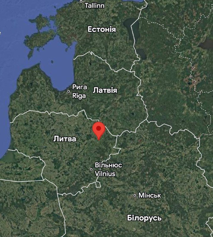 A satellite map shows a red location pin marking a spot in northern Lithuania, bordered by Latvia, Belarus, and the Baltic Sea, with nearby cities labeled in Cyrillic and Latin script.