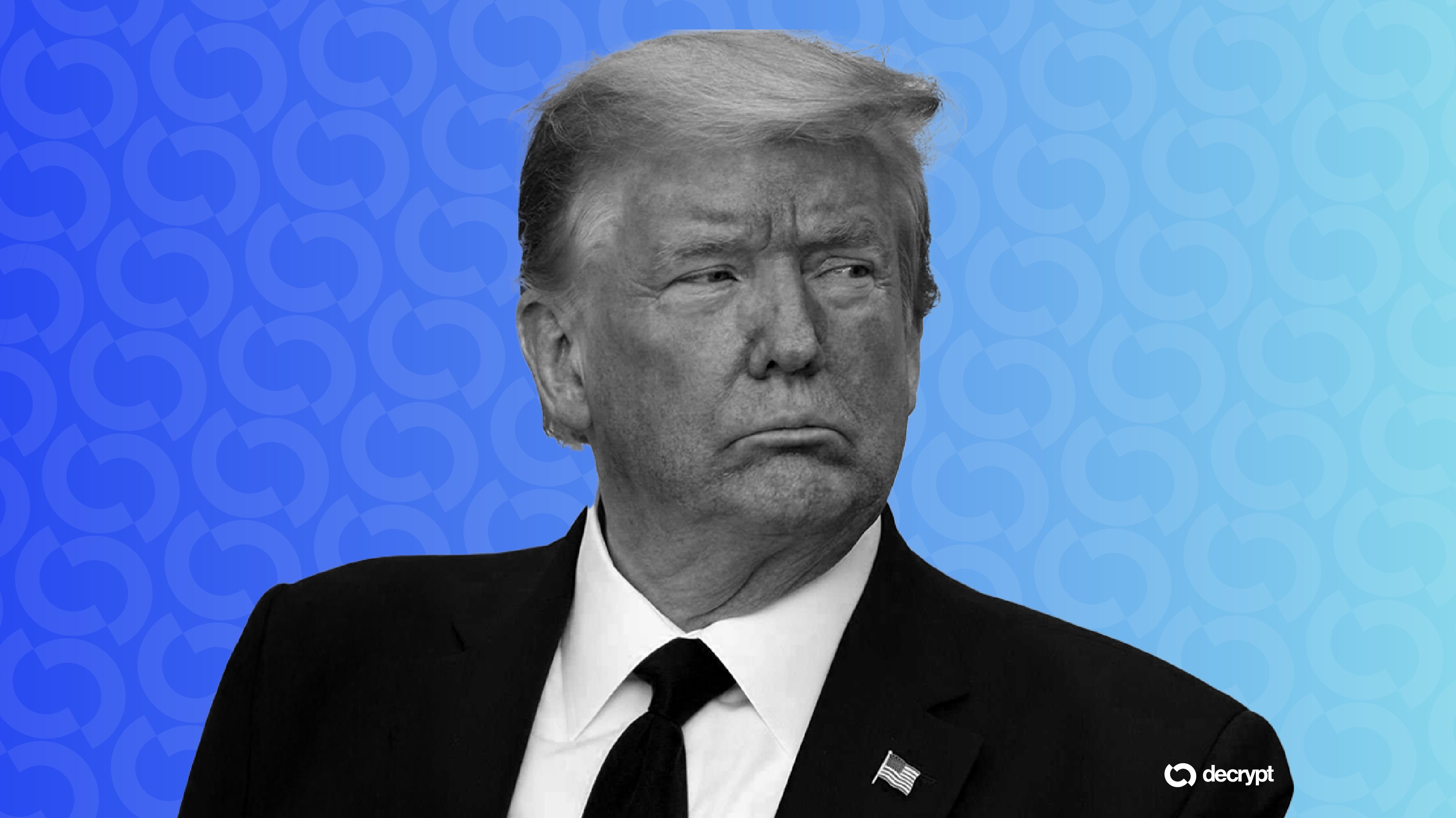 A black-and-white photo shows an older man in a dark suit and tie with an American flag pin, set against a blue patterned background featuring the "decrypt" logo.