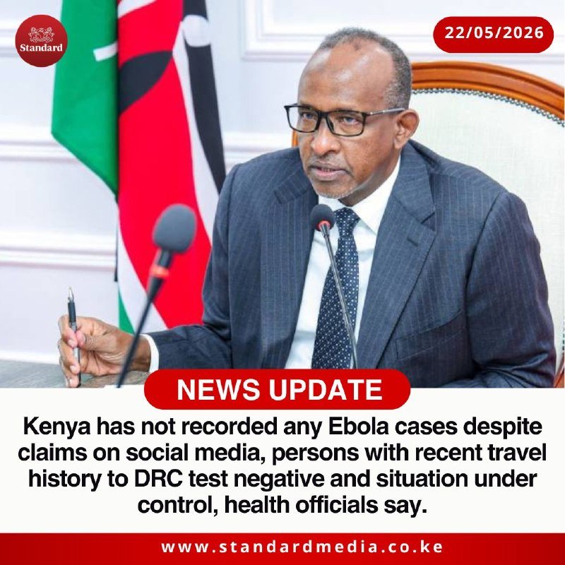 A bespectacled man in a suit sits before microphones with a Kenyan flag behind him, shown in a news graphic dated 22/05/2026 stating Kenya has no Ebola cases.