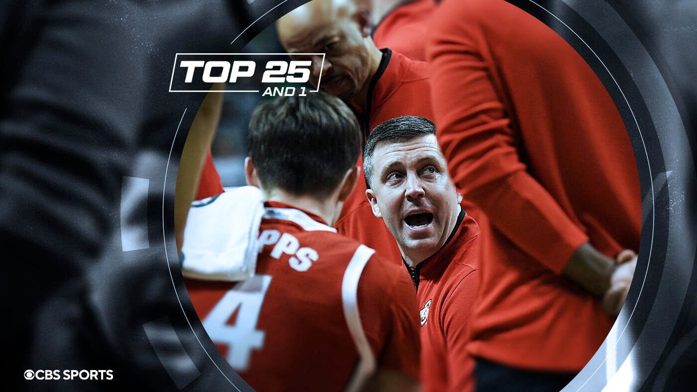 A graphic overlay labeled "TOP 25 AND 1" shows a basketball coach in a red pullover speaking emphatically during a team huddle.