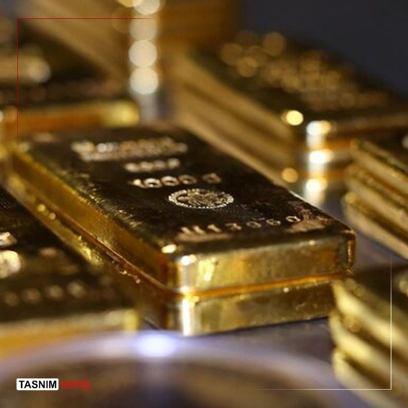 Stacks of shiny gold bars stamped with "999.9 FINE GOLD" and serial numbers are piled together in a close-up photograph.