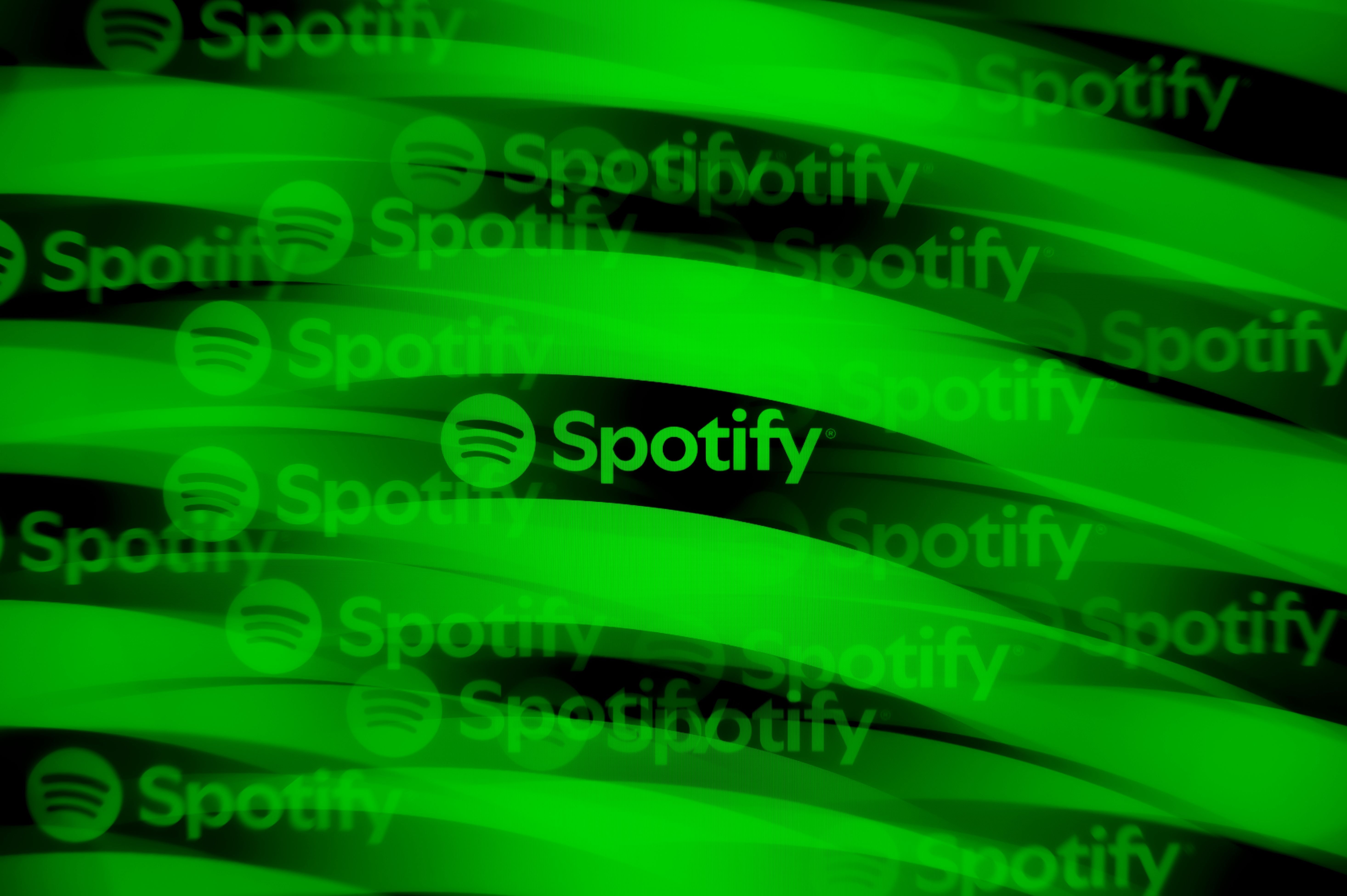 A digital graphic displays multiple Spotify logos with its circular sound-wave icon repeated across flowing green and black wave patterns.
