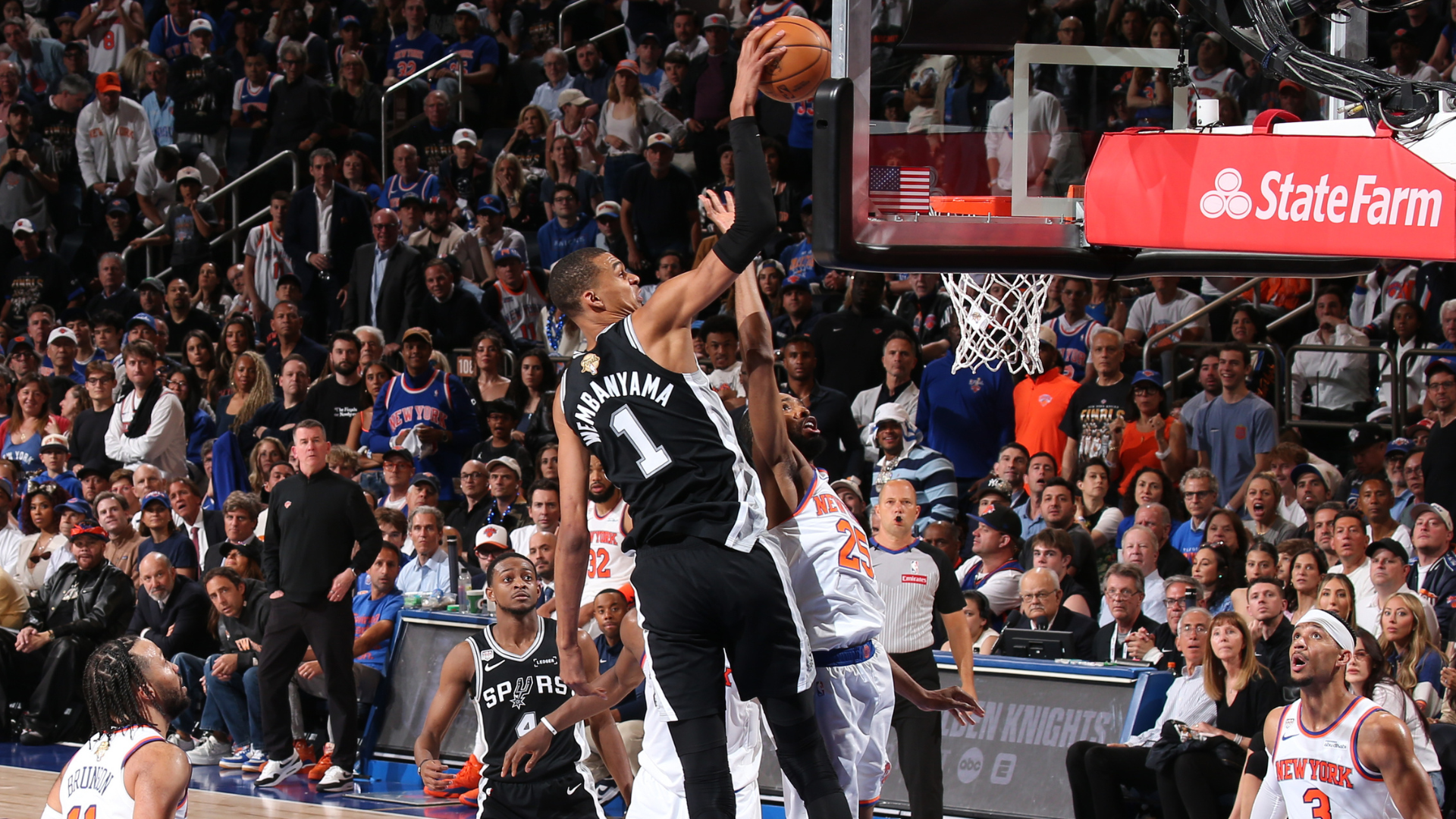 Spurs players celebrate on the floor at Madison Square Garden after their Game 3 win.