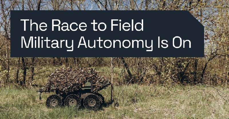 A camouflage-draped, multi-wheeled unmanned ground vehicle sits in a wooded field, beneath an overlaid text banner reading "The Race to Field Military Autonomy Is On."