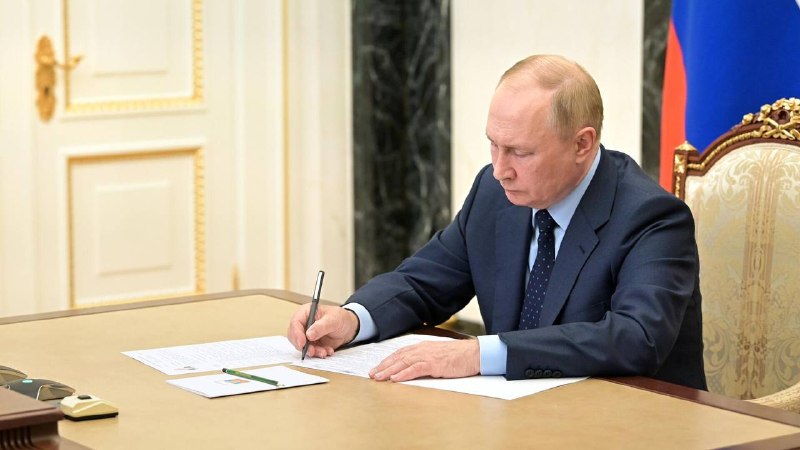 Vladimir Putin at a formal signing ceremony in the Kremlin, the setting for the 10 June 2026 migration law.