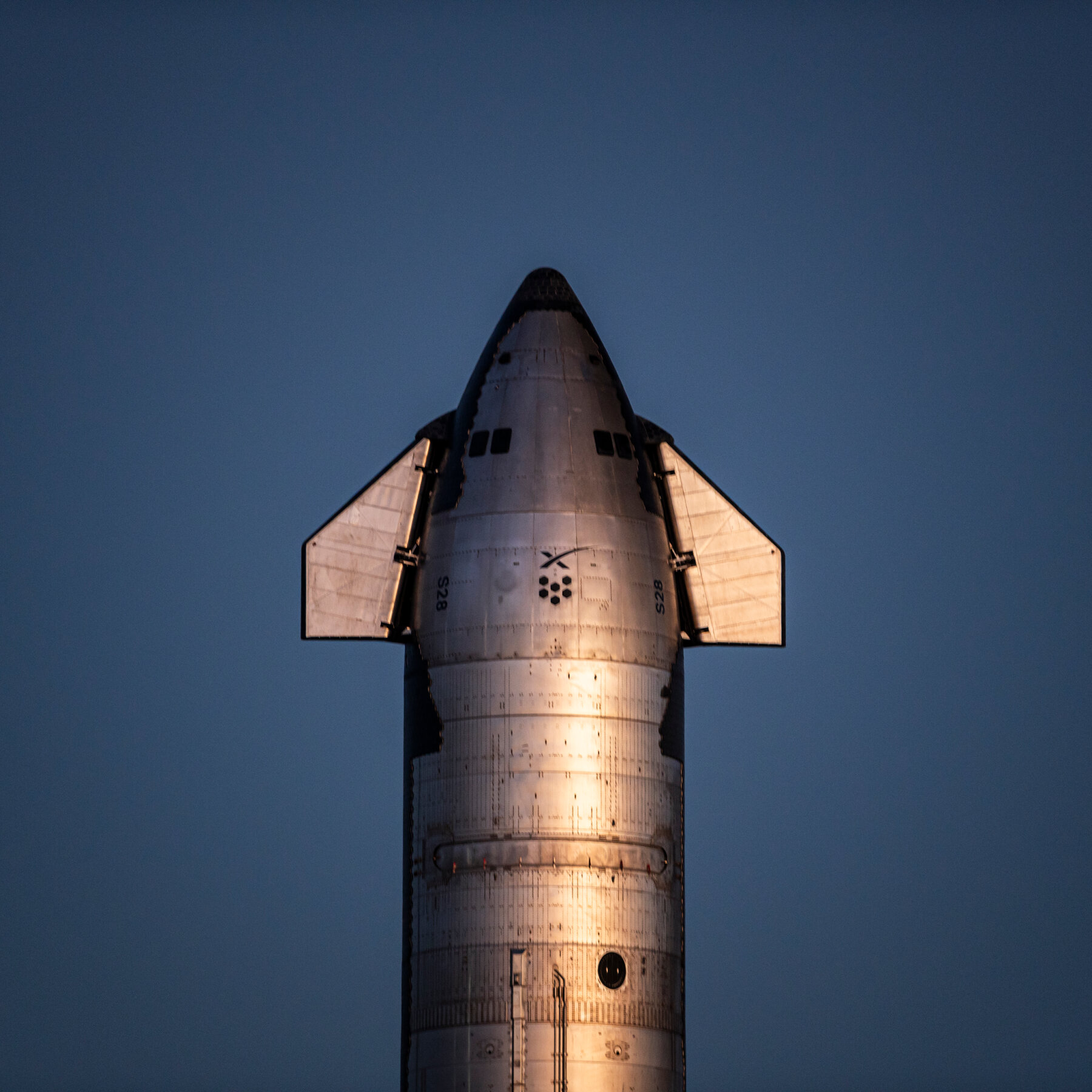 A Falcon 9 on the pad at Cape Canaveral ahead of a commercial manifest that now sits beneath a public ticker.
