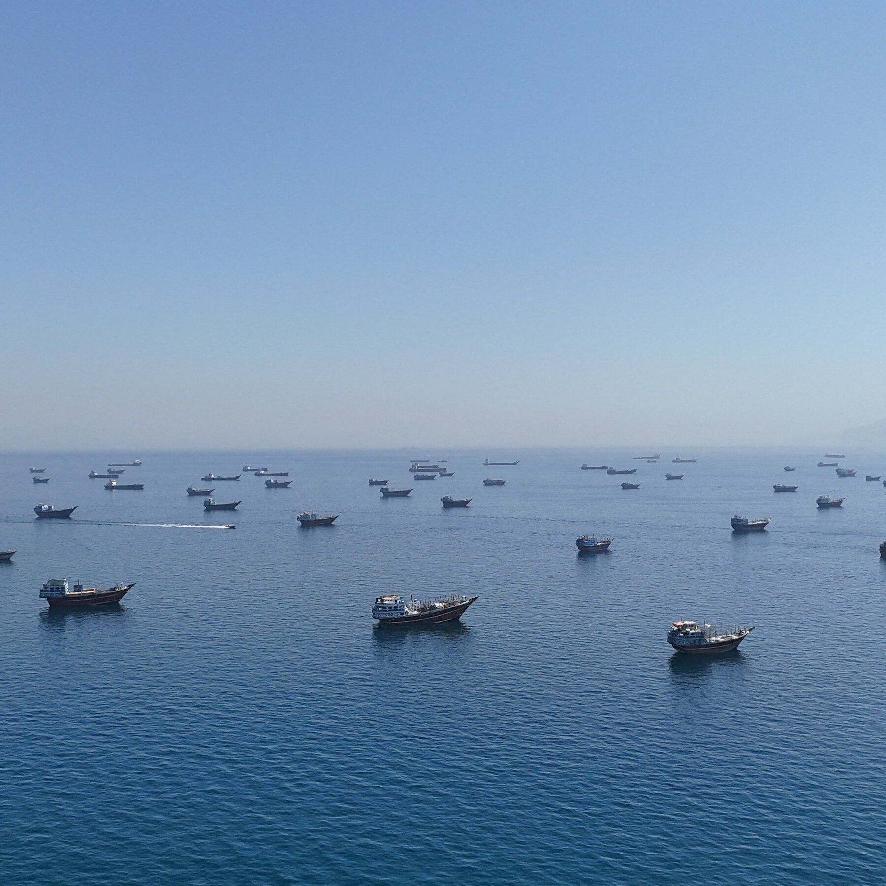 Smoke rises over Iranian coastal infrastructure along the Strait of Hormuz following US strikes reported on 11 June 2026.