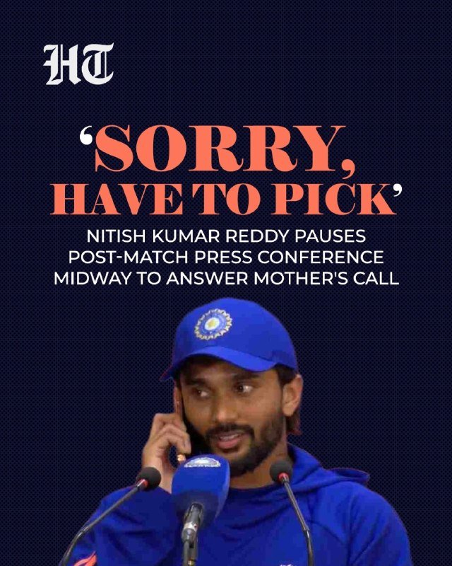 A bearded man in a blue BCCI cap and jersey holds a phone to his ear in front of microphones, beneath text reading "SORRY, HAVE TO PICK."