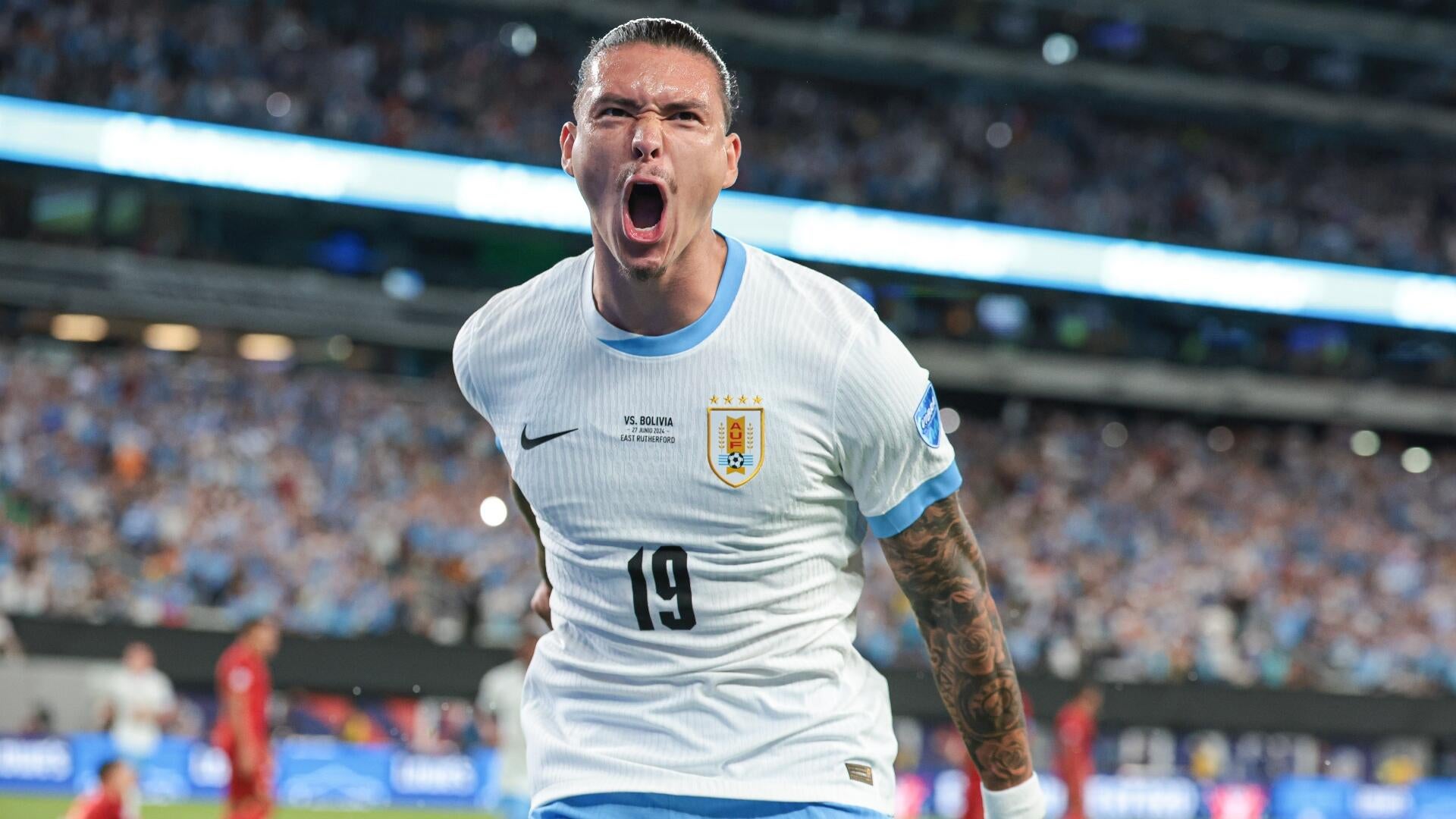 A DraftKings Sports promotional graphic advertises a "Spend $5 Get $200 Instantly in Bonuses" offer for new customers, featuring a soccer ball patterned with various national flags.