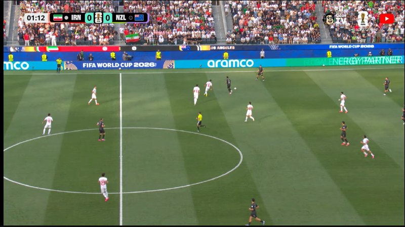 A blonde, bearded soccer player wearing a red Belgium national team jersey with the number 7 runs across the field during a match.