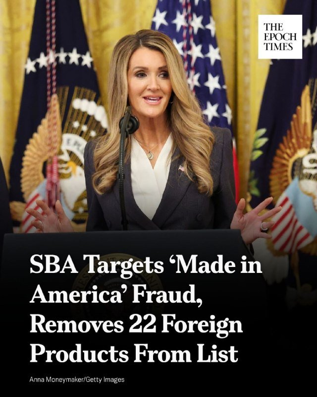A blonde woman in a dark blazer speaks at a podium with an American flag backdrop; caption reads "SBA Targets 'Made in America' Fraud, Removes 22 Foreign Products From List."