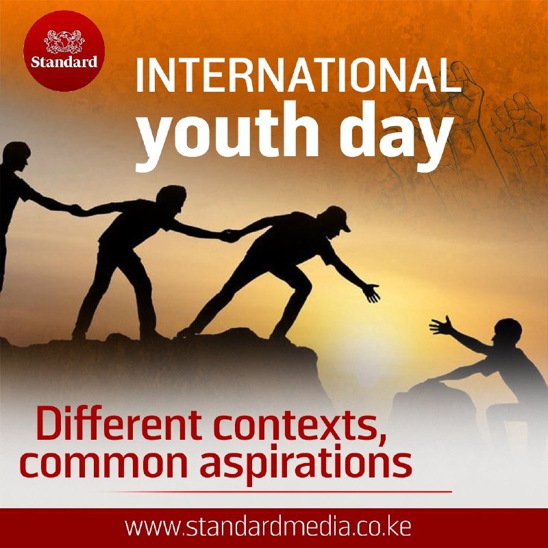 A graphic illustration for International Youth Day shows silhouettes of three figures pulling another person up onto a rocky ledge against a sunset background, with a raised fist and a "Standard" logo.