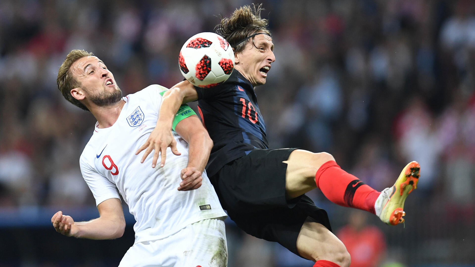 A USA soccer player wearing jersey number 20 controls a ball mid-air with his foot during a match.