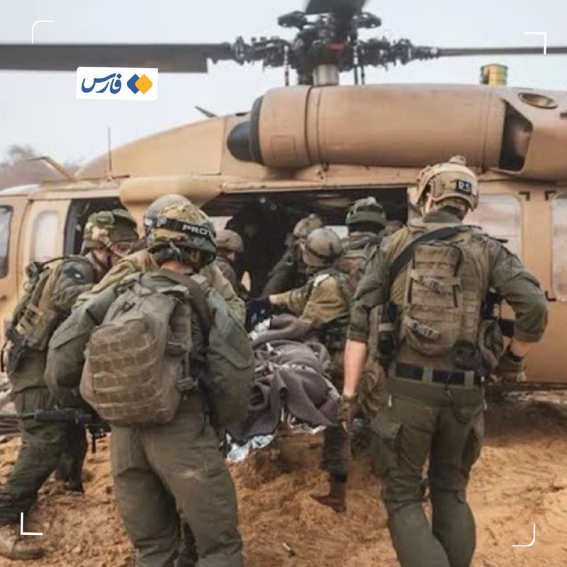 Armed soldiers in helmets and combat gear approach a military helicopter on a dusty, smoke-filled dirt landing zone.