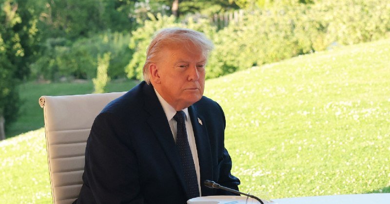 Press TV broadcast graphic featuring Dmitry Trenin alongside circular portraits of Donald Trump and another man holding a signed document, with US and Iranian flags in the background.