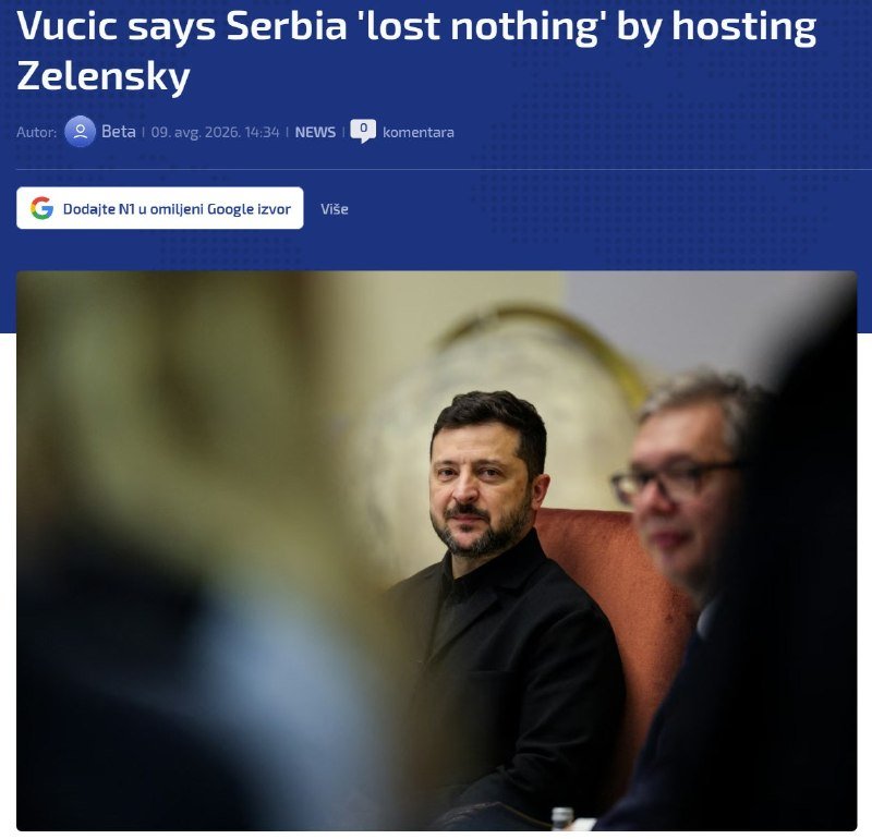 A bearded man in a black shirt sits beside another man wearing glasses, with blurred figures in the foreground, beneath a headline reading "Vucic says Serbia 'lost nothing' by hosting Zelensky."