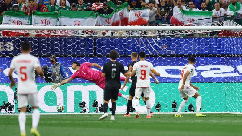 A USMNT player in a #16 red-and-white striped jersey runs with arms outstretched in celebration during a match against Australia, with a graphic showing a 0-2 score.