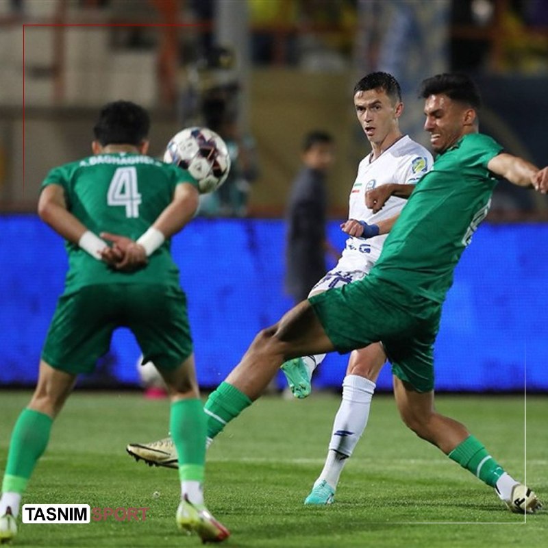 A side-by-side image shows a bearded goalkeeper in a light blue Iran jersey holding a trophy on the left, and a red-haired player in a red Belgium number 7 jersey on the right, with "@TRANSFERMARKT" text below.