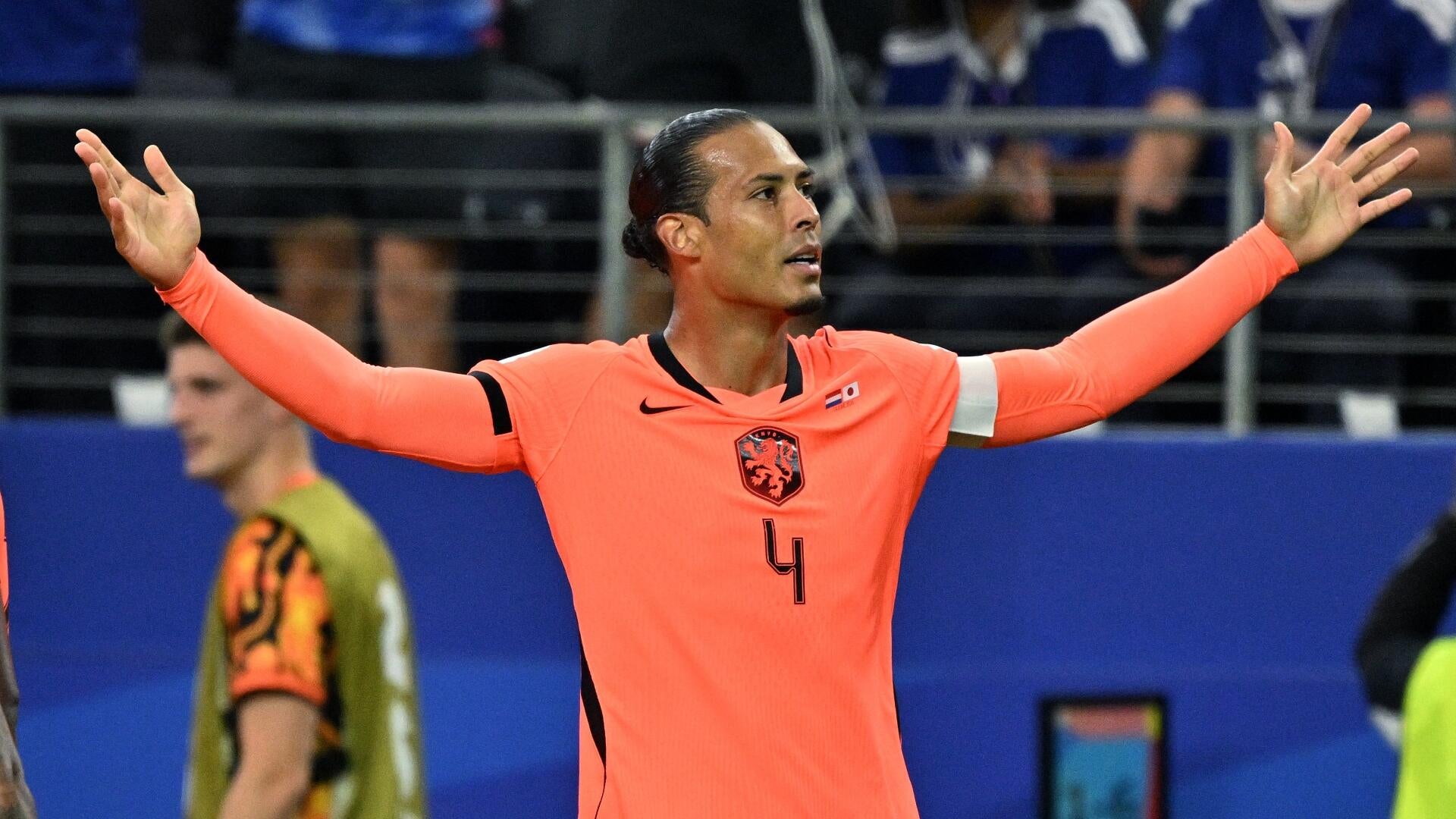 A soccer player wearing a yellow Brazil jersey with the number 7 celebrates with arms outstretched on the field during a match.