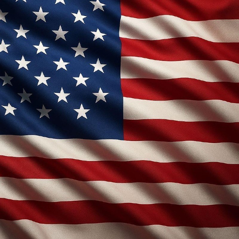 Close-up of a waving United States flag, showing the blue star-filled canton and red and white stripes.