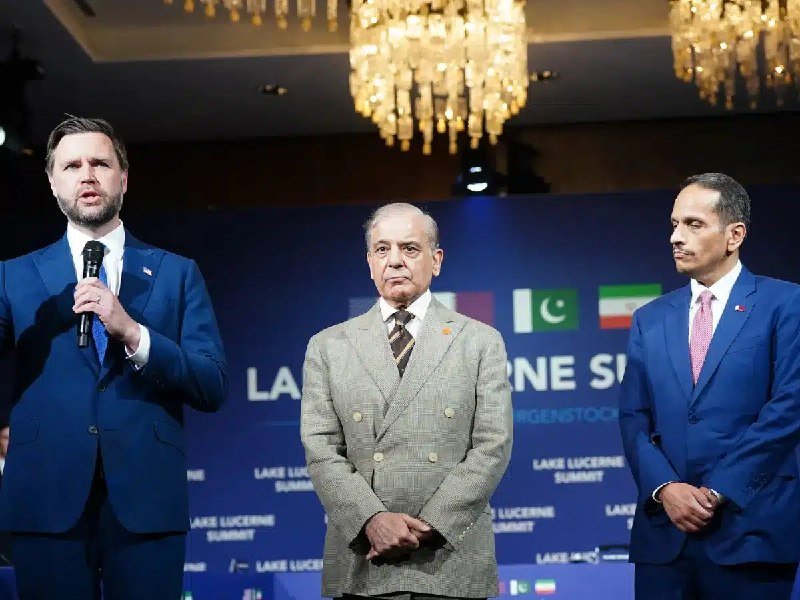 Three men in suits stand before a "Lake Lucerne Summit" backdrop displaying Pakistan and Iranian flags, with the leftmost man speaking into a microphone.
