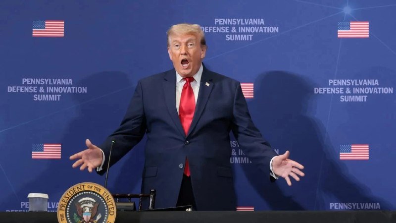 A man in a dark suit and red tie speaks animatedly with arms outstretched at a podium bearing the presidential seal, against a backdrop reading "Pennsylvania Defense & Innovation Summit" with American flags.