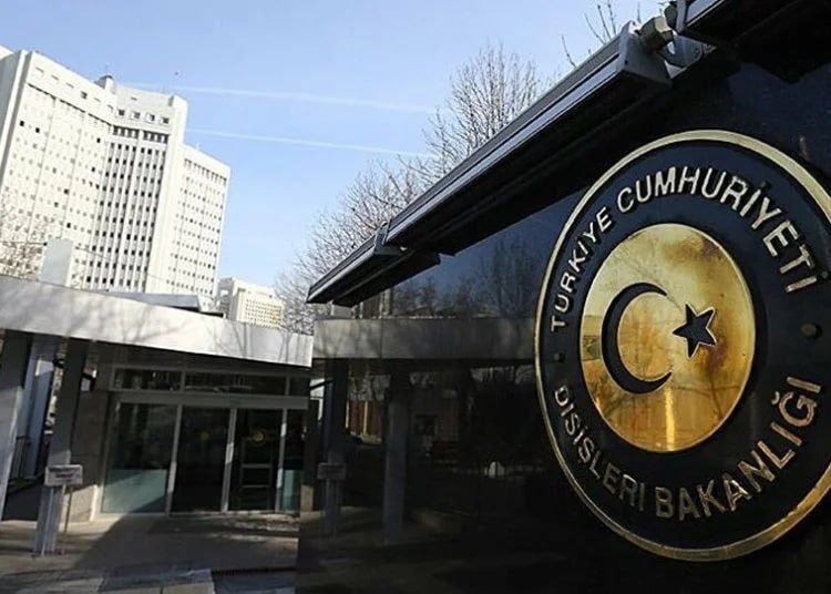 The Turkish Foreign Ministry's emblem, reading "Türkiye Cumhuriyeti Dışişleri Bakanlığı," is displayed on a gate outside a building.