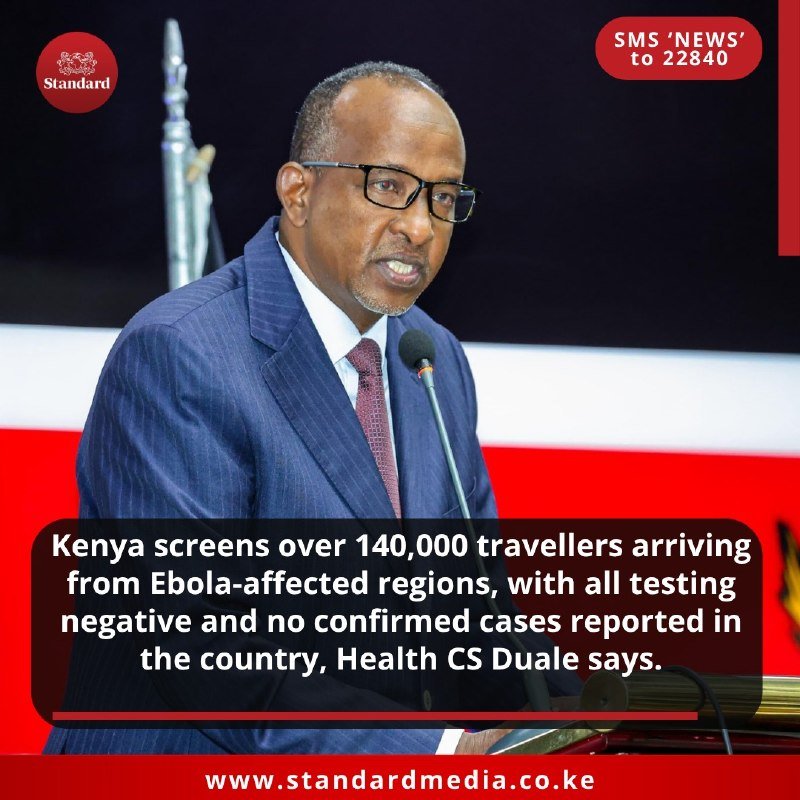 A man in a blue pinstripe suit and glasses speaks into a microphone at a podium, with a news graphic overlay reading "Kenya screens over 140,000 travellers arriving from Ebola-affected regions."