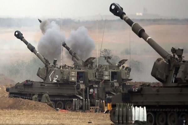 Self-propelled howitzers fire their cannons, producing smoke plumes, while soldiers operate the artillery in an open field with stacks of projectiles nearby.