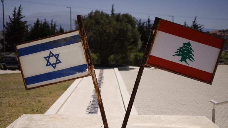 Two men in suits shake hands before American and Israeli flags, flanked by other officials, in a graphic reading "'First step towards peace' ISRAEL, LEBANON SIGN FRAMEWORK AGREEMENT WITH US."