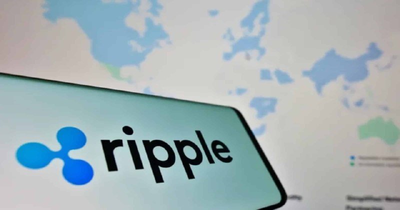 A smartphone displays the Ripple logo and name against a blurred background showing a world map graphic.