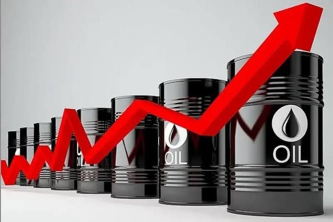 Black oil barrels labeled "OIL" are arranged in a row, increasing in size from left to right, with a red upward-trending arrow graphic overlaid across them.