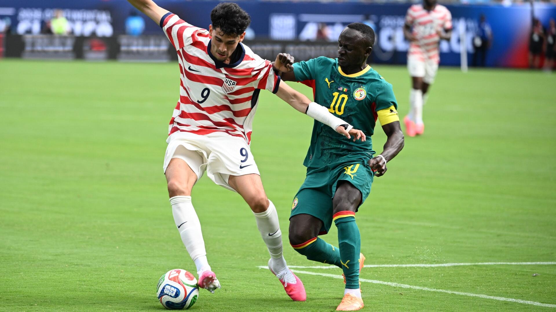 A graphic displays a "Germany vs Paraguay" FIFA World Cup 2026 matchup, featuring headshots of two soccer players flanking team logos, starting lineups, and 4-2-3-1 formations.