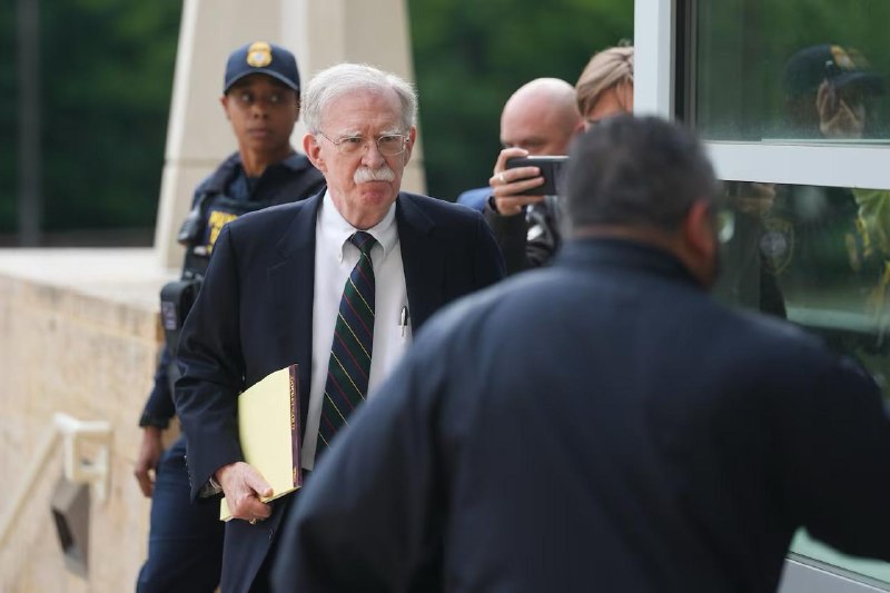 On a single Friday, the former national security adviser admitted mishandling classified material while the sitting White House leaned on a frontier AI lab to slow its own release.