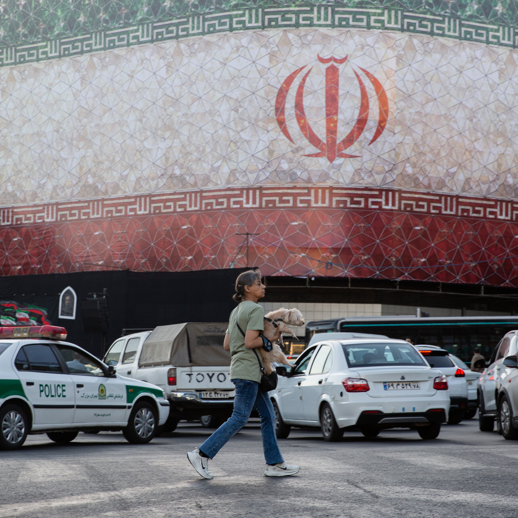 The Iranian flag waves in front of a large golden Bitcoin coin in a digital illustration.
