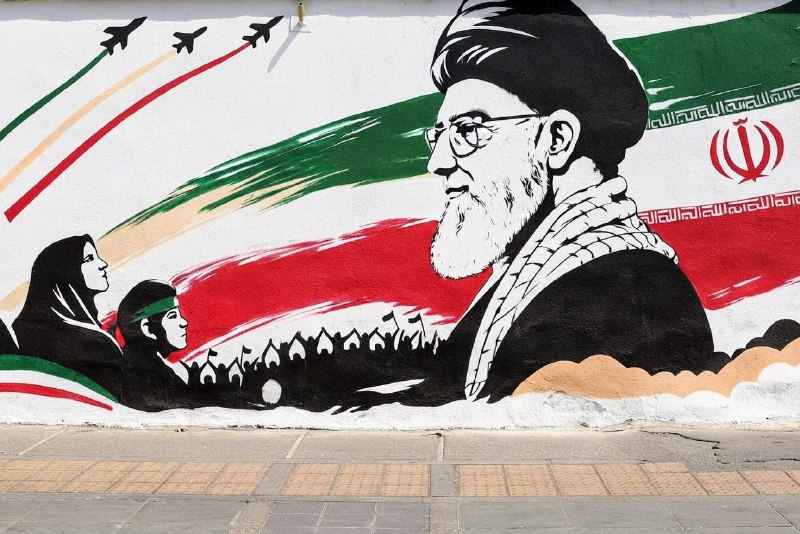 Tehran calls the US strike on the frigate Dena a war crime and pledges international legal action, but the combatant-status question that would decide such a case remains unresolved on the open record.