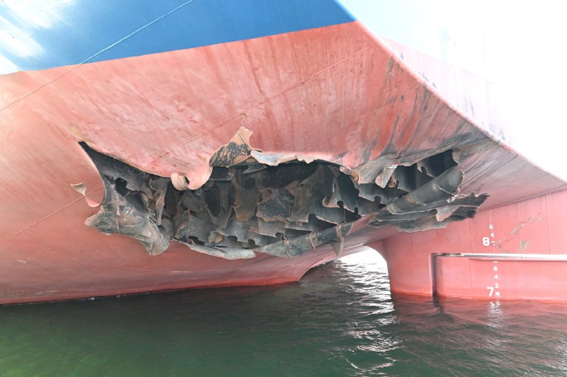 South Korea's HMM-operated cargo vessel Namu sits damaged in the Strait of Hormuz, with departure pushed past mid-July — a small incident that exposes how thinly the so-called freedom-of-navigation order is actually policed.