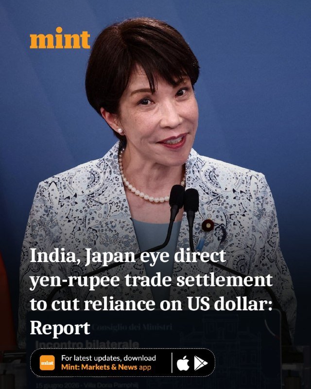 A woman with short dark hair and a pearl necklace speaks at a podium with microphones against a blue backdrop, overlaid with the "Mint" logo and headline text.